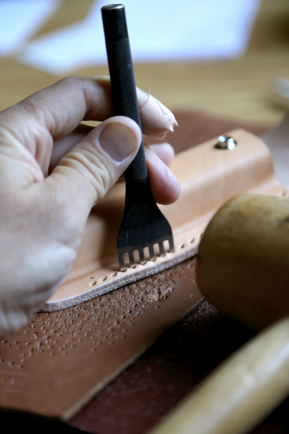 Pricking iron marking stitch holes on leather